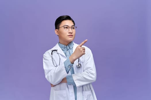 Doctor or medic pointing finger on invisible transparent screen with copy space and advertising area