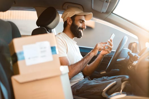 Arabic Deliveryman Texting Via Cellphone Receiving Online Order In Auto