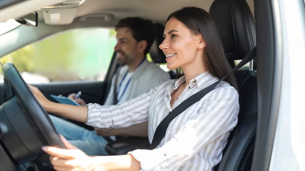 Cheerful confident young woman passing exams at driving school