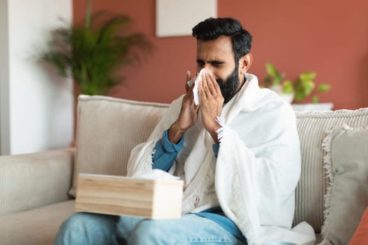 Middle Eastern Guy suffering from sickness blowing nose at home