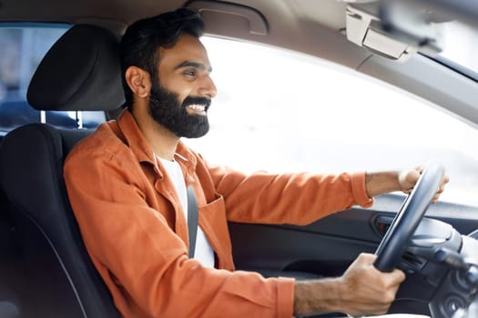 Indian Man Driving Enjoying New Modern Vehicle Sitting In Automobile