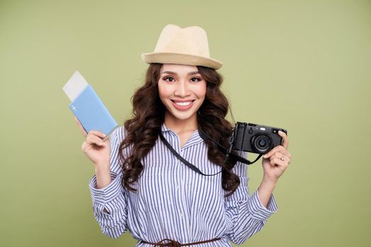 Young asian female traveler in casual clothing holding an amateur digital camera.