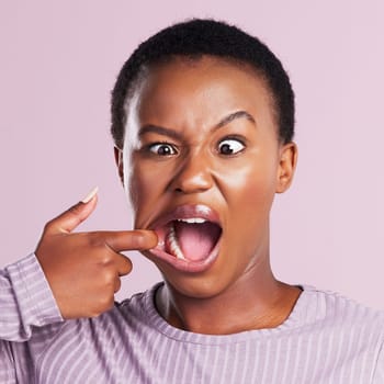 Woman, squint and face in pink studio background with closeup in africa with meme. Female person, portrait and squinting eyes for comedy expression with joy and goofy girl with weird or crazy look.