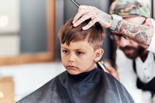 Youre never too you to start looking your best. Cropped shot an adorable little boy getting a haircut at the barbershop.