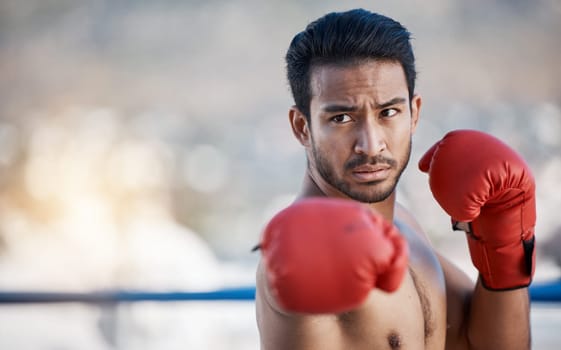 Fitness, boxing or male boxer in a ring training, exercise and punching with strong power in workout. Athlete, challenge or healthy Asian man fighting on city rooftop outdoors for skills development