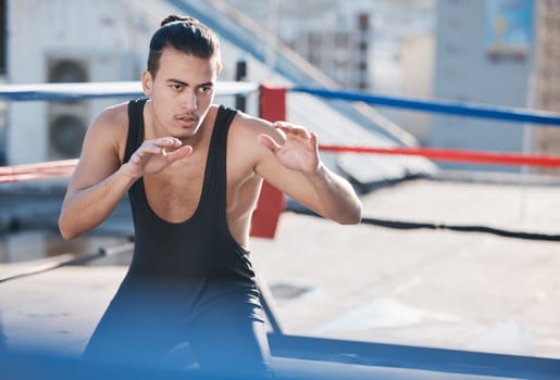 Man, wrestler and fight with in ring training on rooftop with for sport competition in outdoor. Athlete, fitness and wrestling with martial arts for workout in city with serious face for contest
