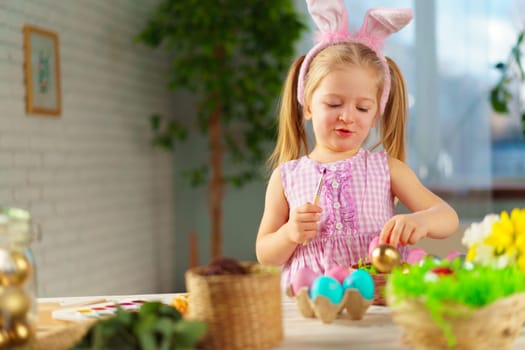 Easter concept. Toddler blonde happy girl with bunny ears