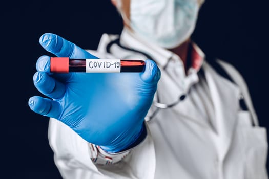 Infected blood sample COVID 19 in sample tube in hand of doctor.