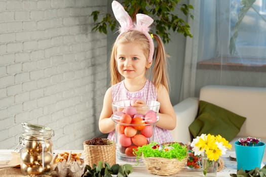 Happy little girl with bunny ears getting ready for Easter party