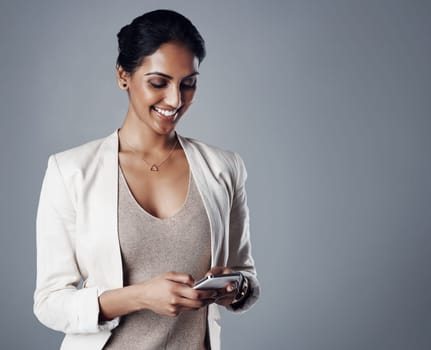 Business, happy and woman with a smartphone, connection and online reading against a grey studio background. Female person, administrator or model with a cellphone, mobile application or website info