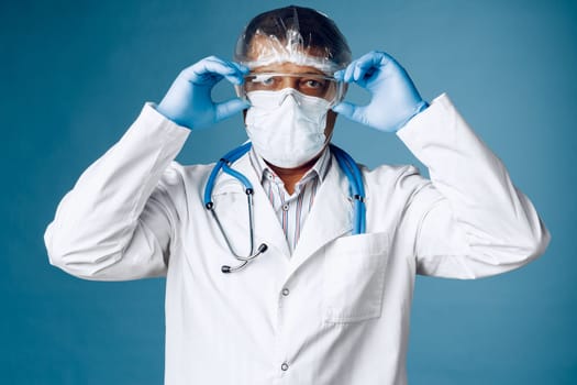 doctor in protective clothing on blue background.