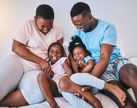 Happy, laugh and black family on a bed with games, tickle and bonding in a home on the weekend. Love, playing and children with parents in a bedroom, playful and having fun in the morning a house