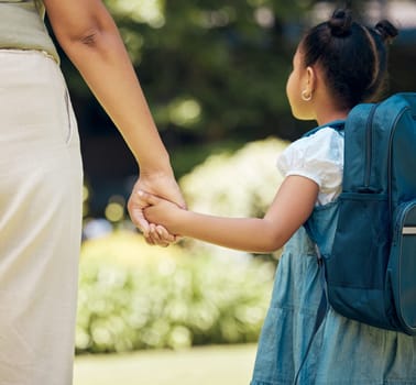 Holding hands, backpack and girl with mother walking to school together outdoor. Hold hand, mom and student walk, travel and journey to kindergarten with care, safety and security, support or bonding