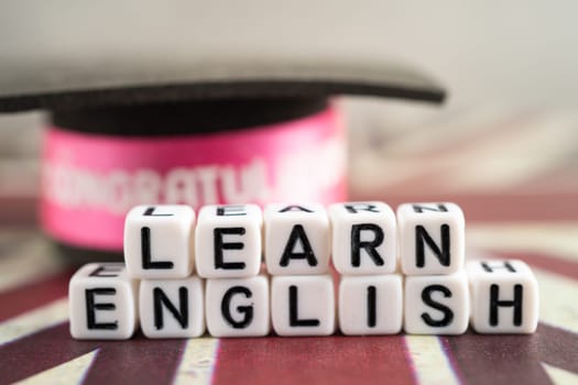 Word Learn English on book with United Kingdom flag, learning English language courses concept.