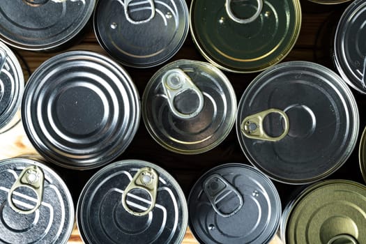 Tin cans with food on the table.
