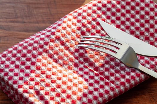Red checkered napkin or tablecloth on wooden table