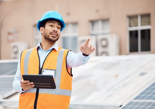 Tablet, planning and male construction worker on a rooftop of a building for inspection or maintenance. Industry, engineering and young man foreman with digital technology working in an urban town.