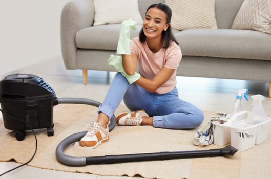 Vacuum, home and woman portrait with a smile from spring cleaning and tidy living room. Lounge, floor and young female person with happiness from clean rug, housekeeping and maid work on carpet