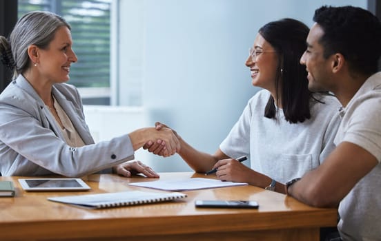 Happy, couple and handshake with financial advisor for deal, agreement or contract. Smile, man and woman shaking hands of broker for finance, loan or mortgage, welcome and thank you for investment.