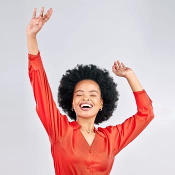 Happy black woman, afro and dancing in celebration for discount, sale or fashion against a white studio background. Excited African female person in happiness for winning, achievement or bonus promo