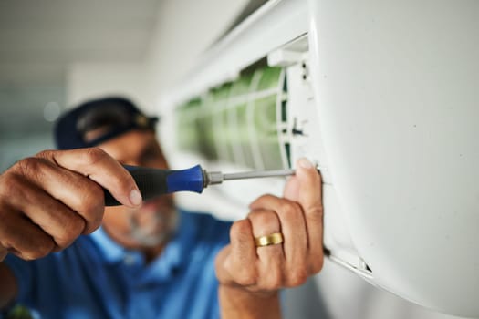 Electrician, hands and air conditioning with man and screwdriver for maintenance, ventilation or power. Engineering, electricity and inspection with closeup of technician for ac repair and contractor