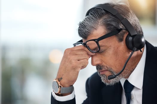 Stress, sales and man in a call center with a headache from telemarketing or technical support. Sad, fail or a mature customer service employee or boss with a mistake or problem with communication