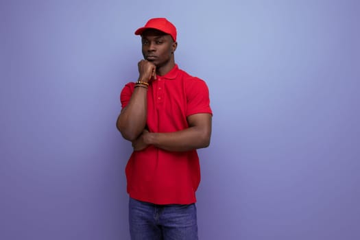 clothing for identity and branding. successful young handsome african man in red corporate t-shirt and cap