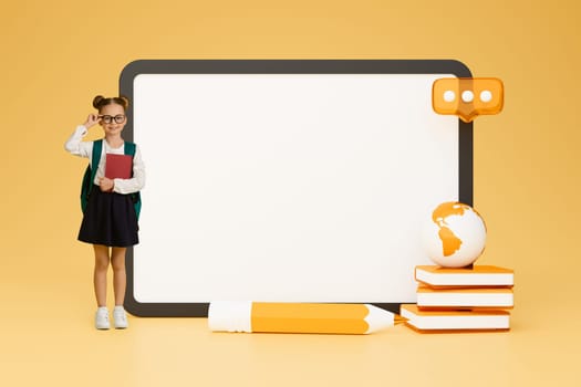 Schoolgirl Posing With Big Tablet Computer Screen On Yellow Background