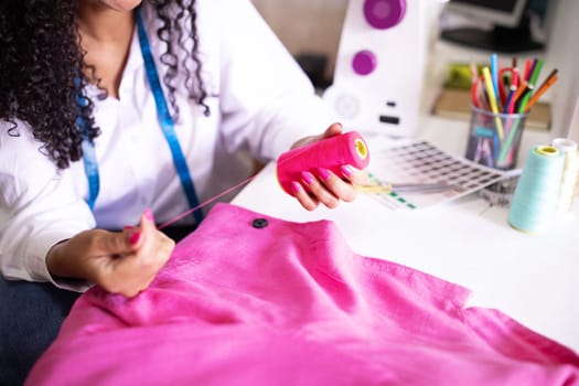 Seamstress Woman Choosing Thread Sitting Near Sewing Machine Indoor, Cropped