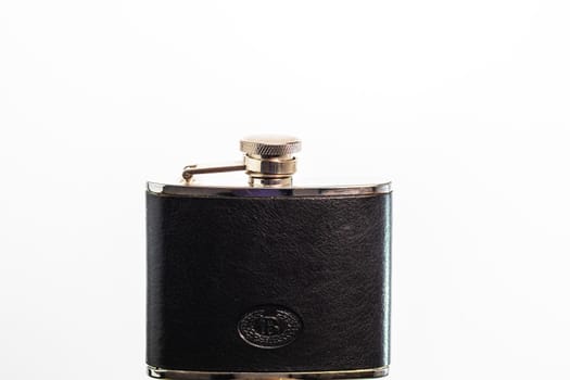 Hip flask to drink alcohol isolated on white