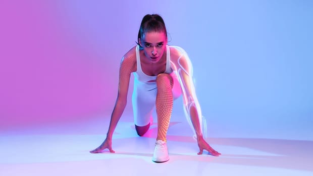 Motivated Woman Runner Doing Crouch Start On Neon Background, Front-View