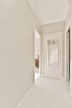 a plain white hallway with a door to a hallway