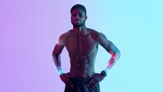 Handsome black sportsman with naked torso posing in neon light