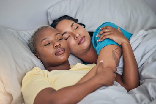 LGBT, bed and relax women sleeping for home wellness, rest and tired together for stress relief, fatigue or calm. Nap, cuddle and young gay people, bisexual partner or lesbian couple dream in bedroom