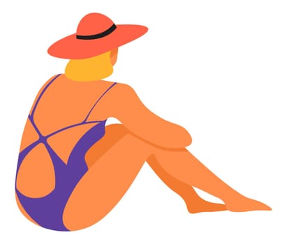 Woman in swimming suit and hat sitting by beach
