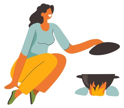 Woman cooking soup on bonfire, camping weekends