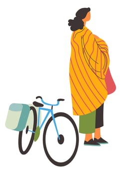 Woman covered in blanket standing by bike vector