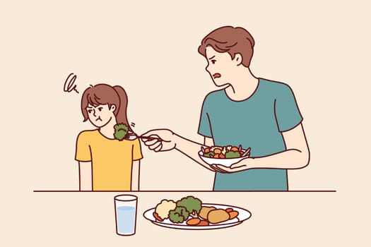 Child does not want to eat salad and vegetables standing near father teach daughter eat healthy food