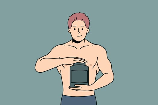 Muscular man holds jar of protein and recommends taking sports nutrition while doing bodybuilding