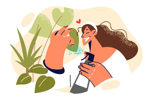Woman caring for houseplants by spraying petals with water and fertilizer for cultivating vegetation