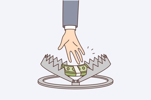 Person hand reaches for money in trap, symbolizing risky income or danger when taking mortgage