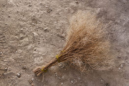a handmade weed broom on the ground, a nostalgia weed broom made in the village,