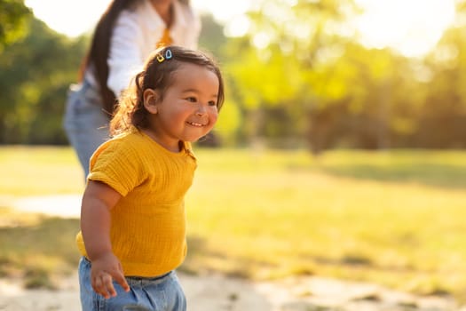 Asian Mommy and Toddler Baby Daughter Laughing While Walking Outdoors