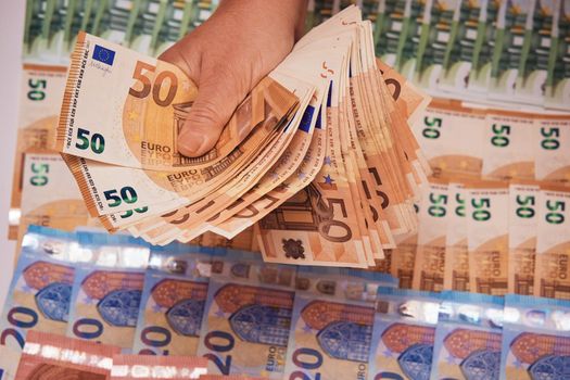 Euro bills in female hands. Euro cash background of money, fan of 50 euros