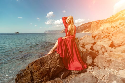 Red dress sea woman. A blonde with flowing hair in a long red dr