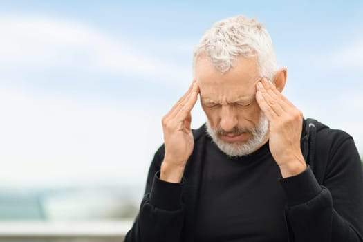 Closeup of elderly sportsman feeling bad while exercising outdoor