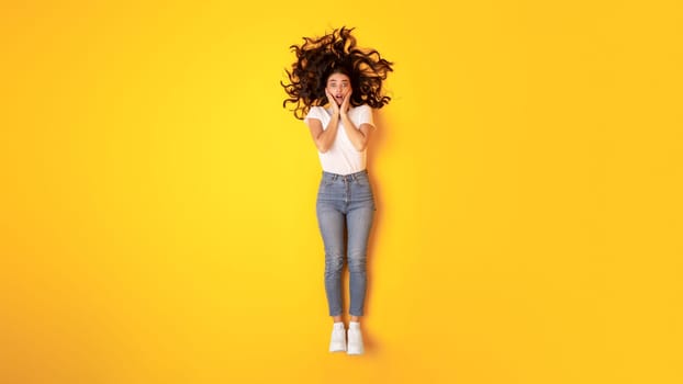 Young Lady In Casual Expressing Shock Over Yellow Background