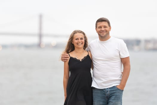 Cute adult married couple standing on the pier