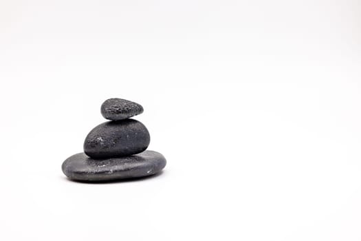 A black stone man cairn cut out on white background