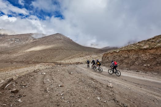 Bicycle tourists in Himalayas asceinding to Khardung La the highest motorable pass in the world